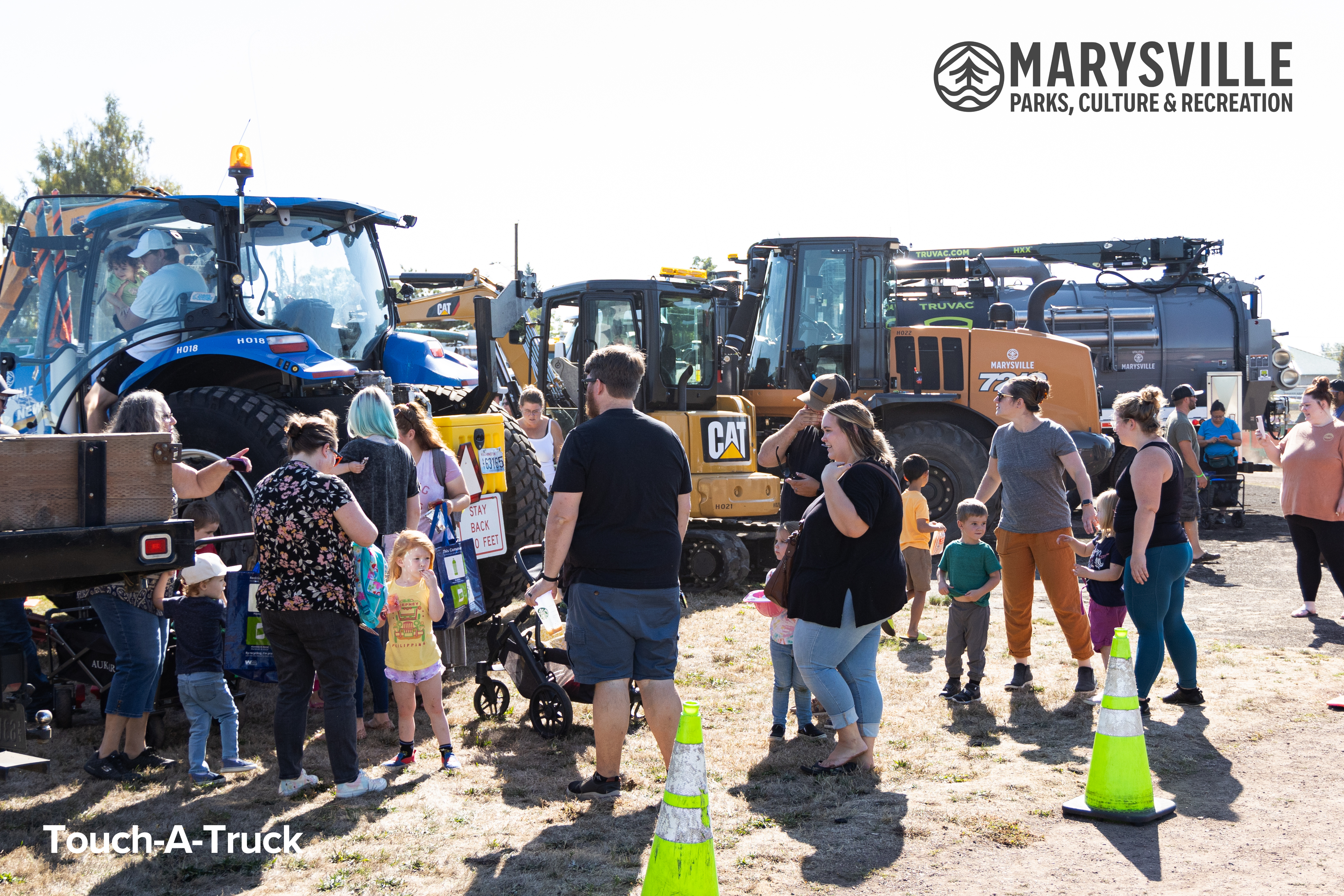 Families Lined up at a Touch-A-Truck event at Asbery Field