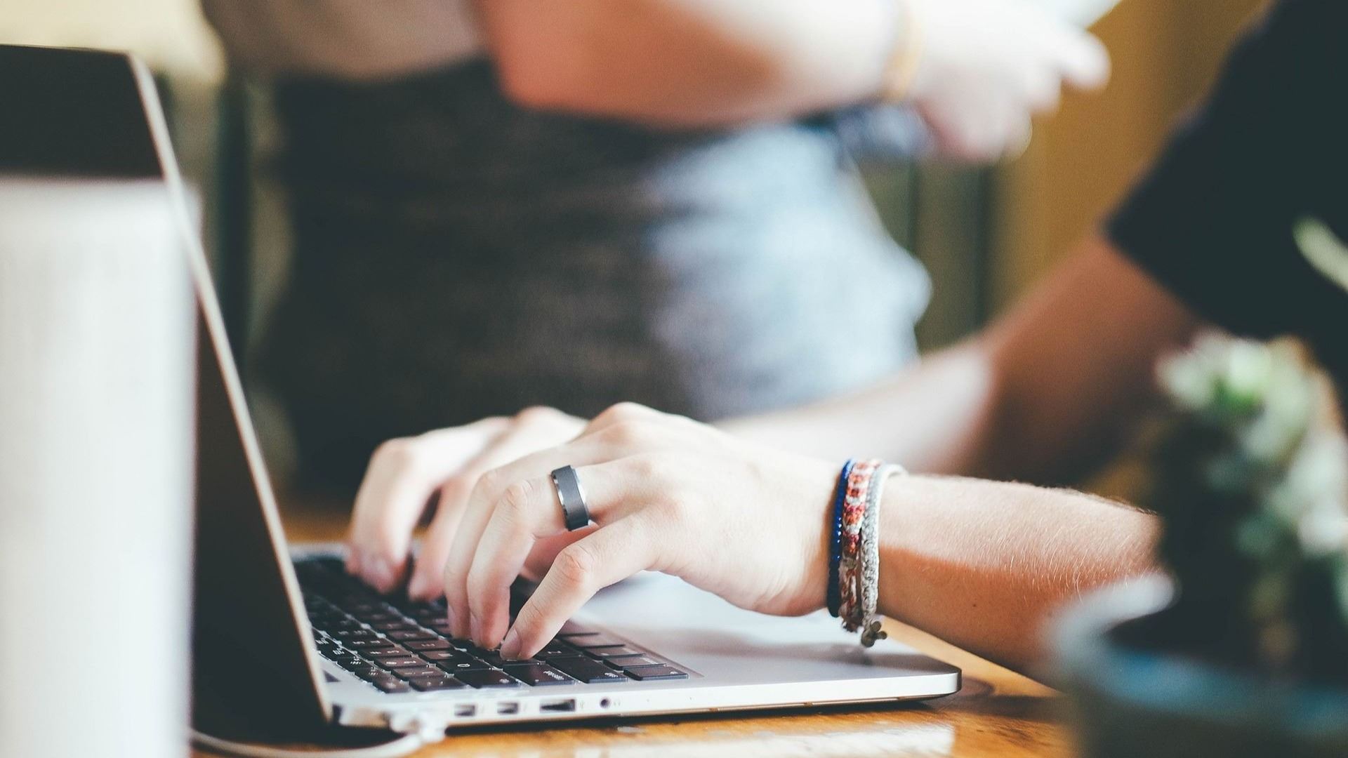 A person types on a laptop